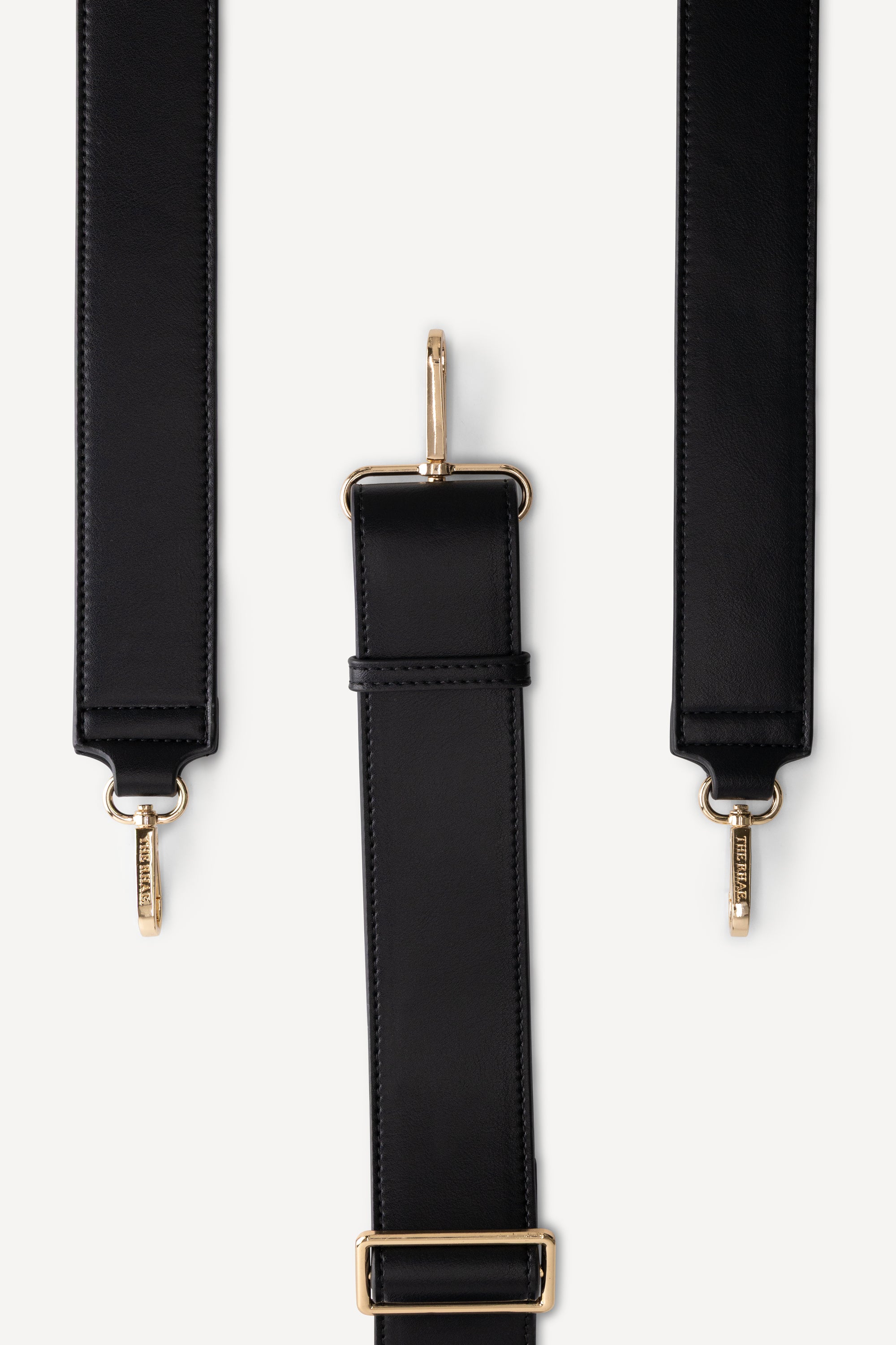 Verstelbare schouderband van The Mosi Black luiertas met goudkleurige hardware
